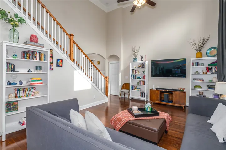 A grand two-story living area features soaring ceilings and rich hardwood flooring, perfect for gracious living.
