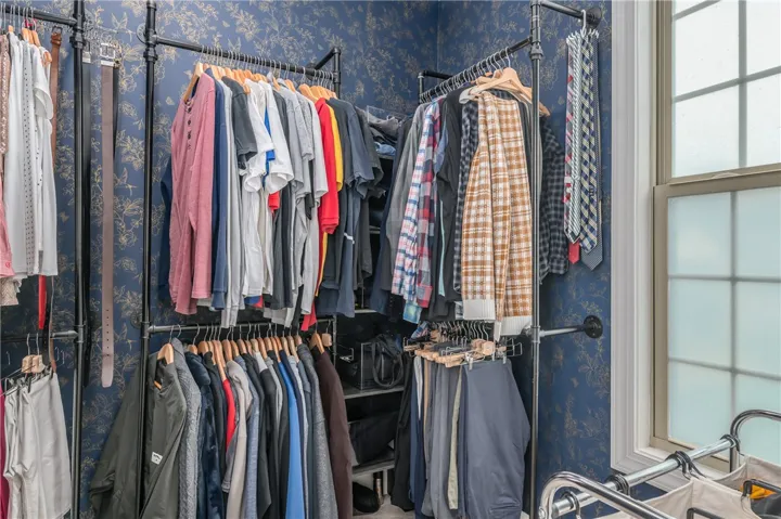 Customizable closet shelving maximizes storage potential for an organized wardrobe.