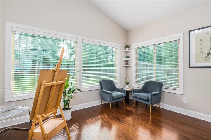 Hardwood floors and generous window lighting define this inviting study.