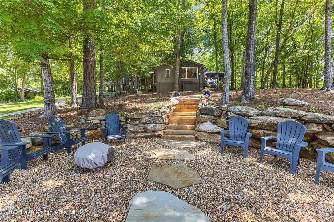 A private, shaded lakeside retreat with a spacious outdoor living area.