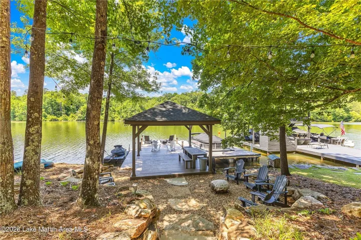 A tranquil lakeside retreat features a covered dock, perfect for relaxing by the water.