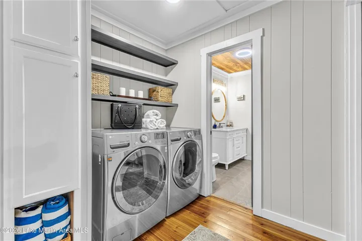 Functional laundry room, adjacent to a well-appointed bathroom, offers both convenience and privacy.