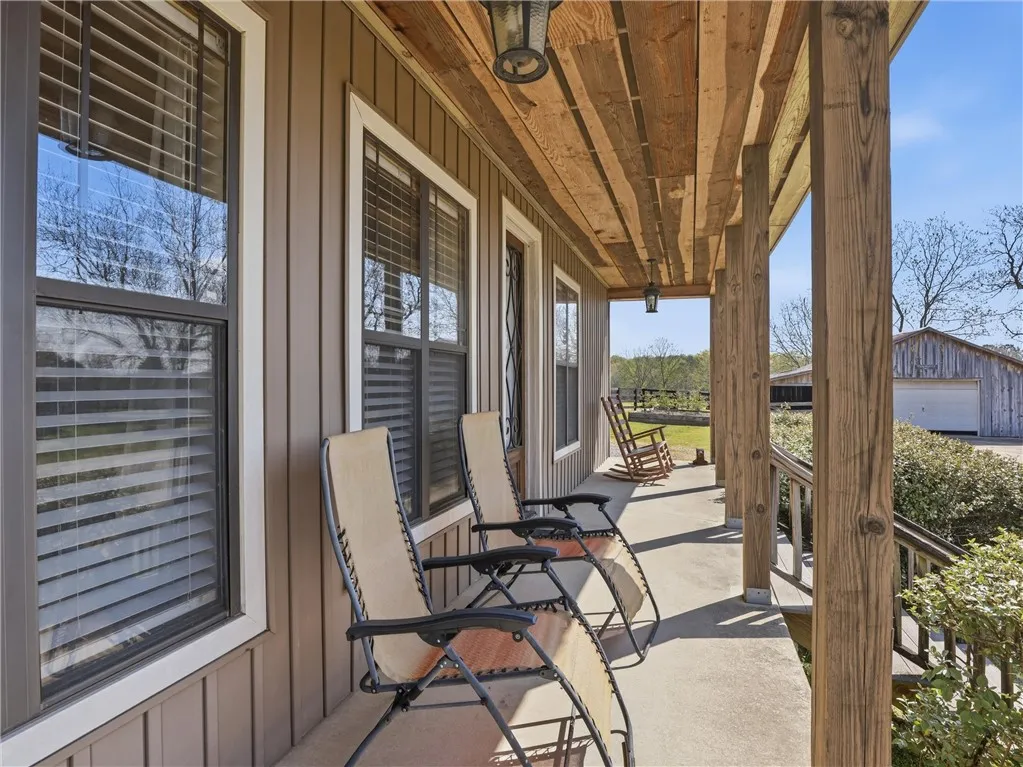 A deep front porch invites relaxation, offering ample space for enjoying the outdoors.