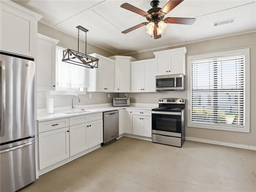 A well-lit kitchen with sleek stainless steel appliances awaits culinary adventures.