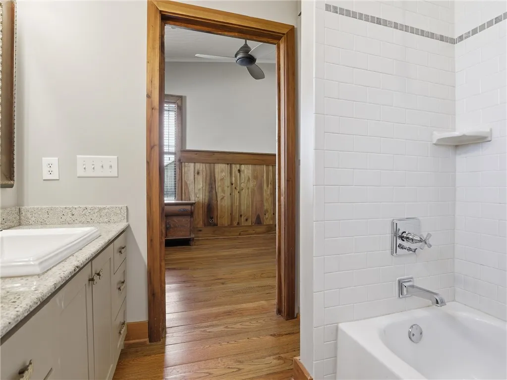 White subway tile adorns the bath, offering a classic aesthetic.