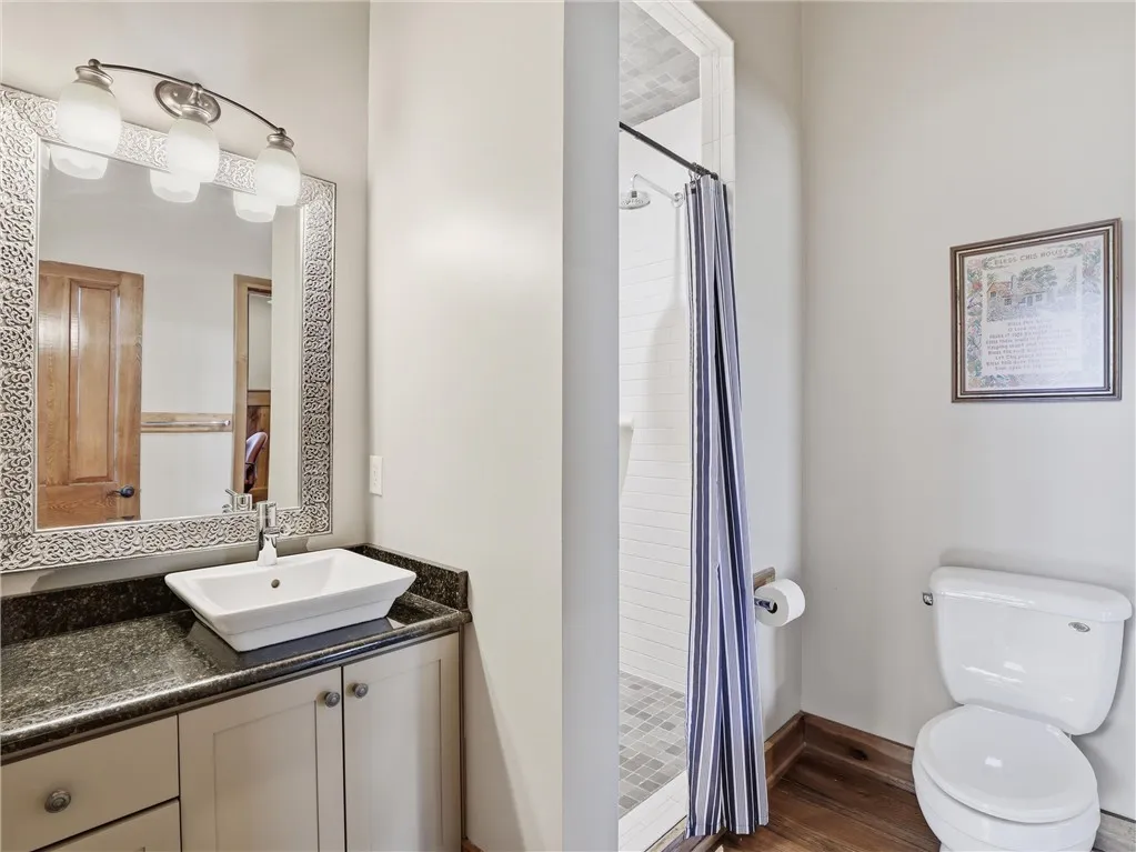 Functional bathroom featuring a vessel sink and shower, offering everyday convenience.