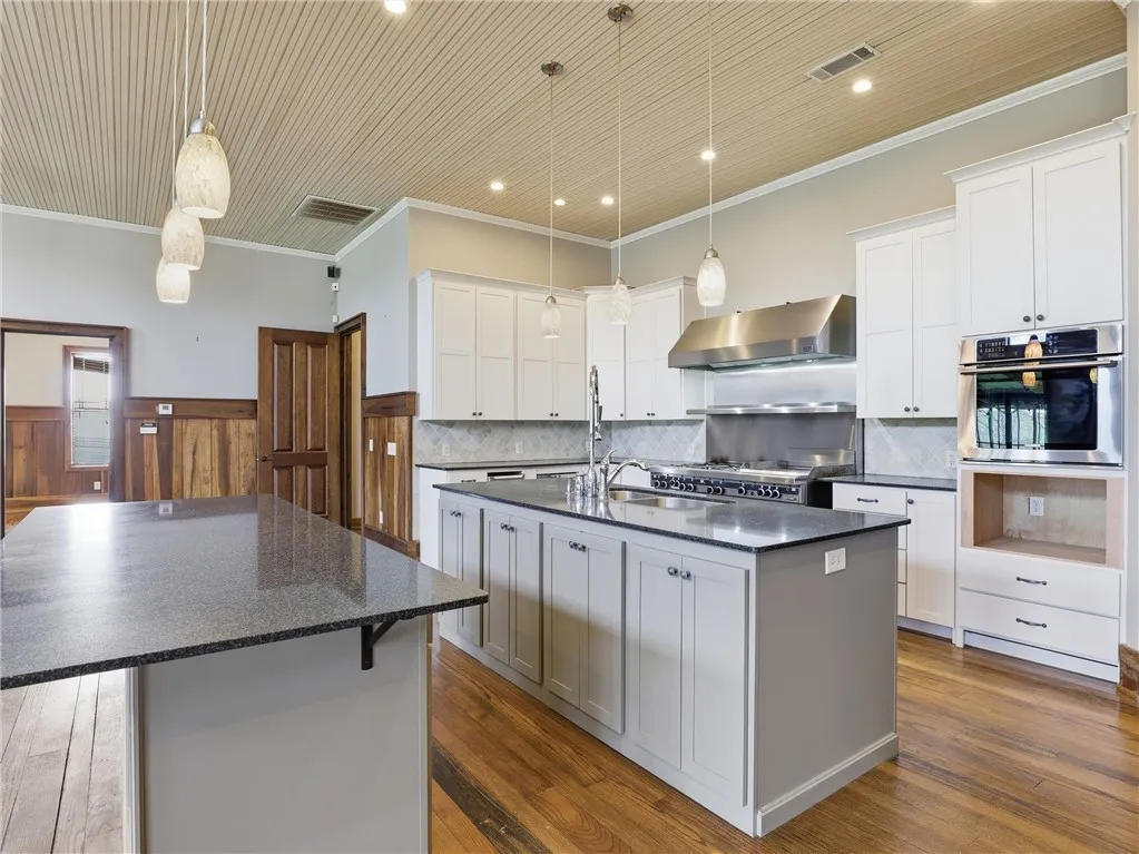 Culinary aspirations find their home in this well-appointed kitchen featuring a substantial island and top-tier appliances.