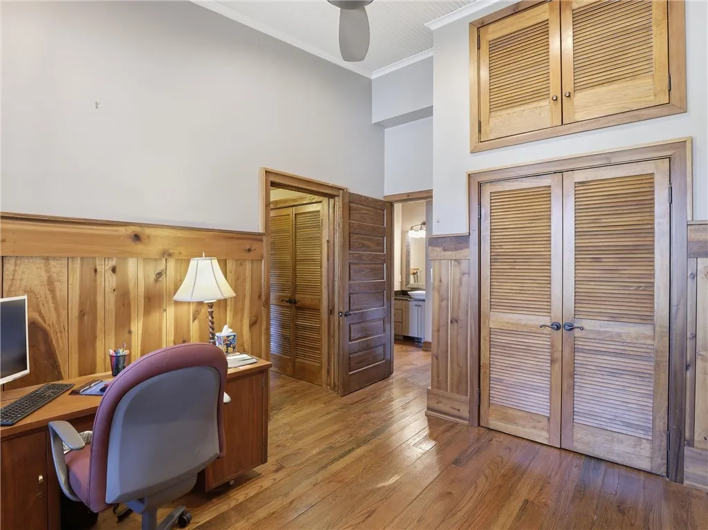 Rich hardwood floors and wood paneling create a warm, inviting workspace.