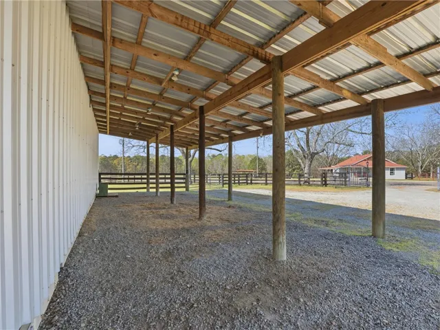 A spacious, sheltered outdoor area provides ample room for activities or storage on this property.