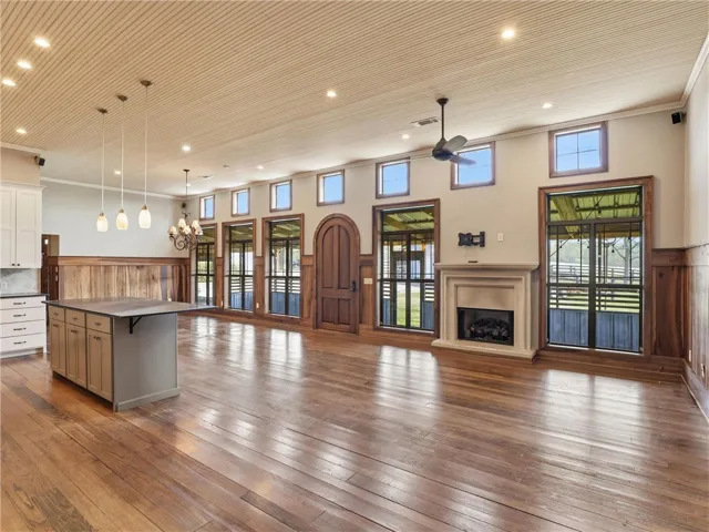 A spacious great room boasts hardwood flooring, an inviting fireplace, and numerous windows.