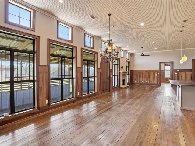 Rich hardwood floors and extensive wainscoting create a warm, inviting great room.
