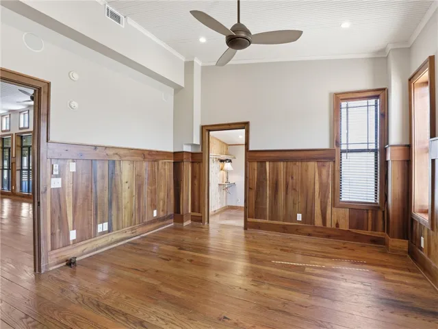 Rich wood paneling and gleaming hardwood floors define this inviting interior space.