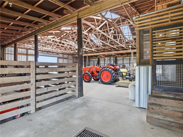 Concrete flooring and high wood-beamed ceilings create an ideal workspace.