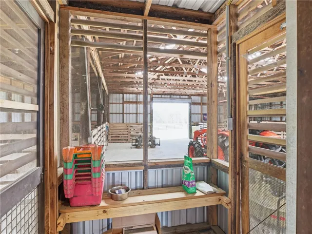 A spacious barn interior with an open layout and robust wooden beams offers ample storage.