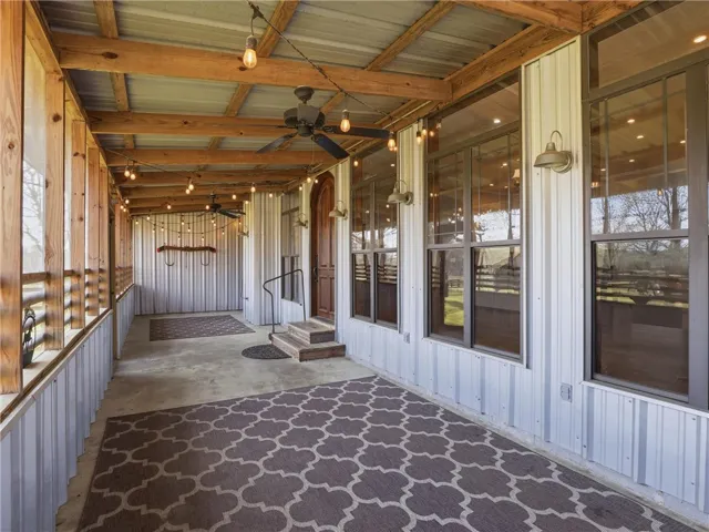 A spacious covered porch invites comfortable outdoor living with ample room for relaxation and entertaining.