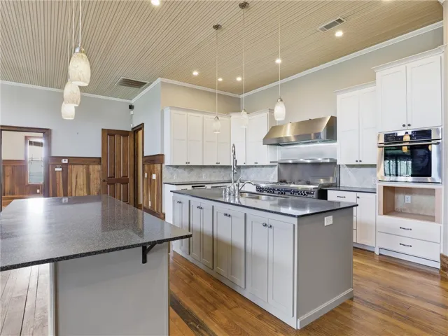 Culinary aspirations find their home in this well-appointed kitchen featuring a substantial island and top-tier appliances.