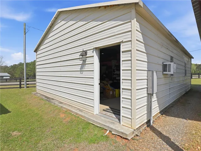 A versatile outbuilding provides additional utility and storage, perfectly complementing the property.