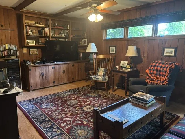 A classic gathering space features warm wood paneling and a coffered ceiling.