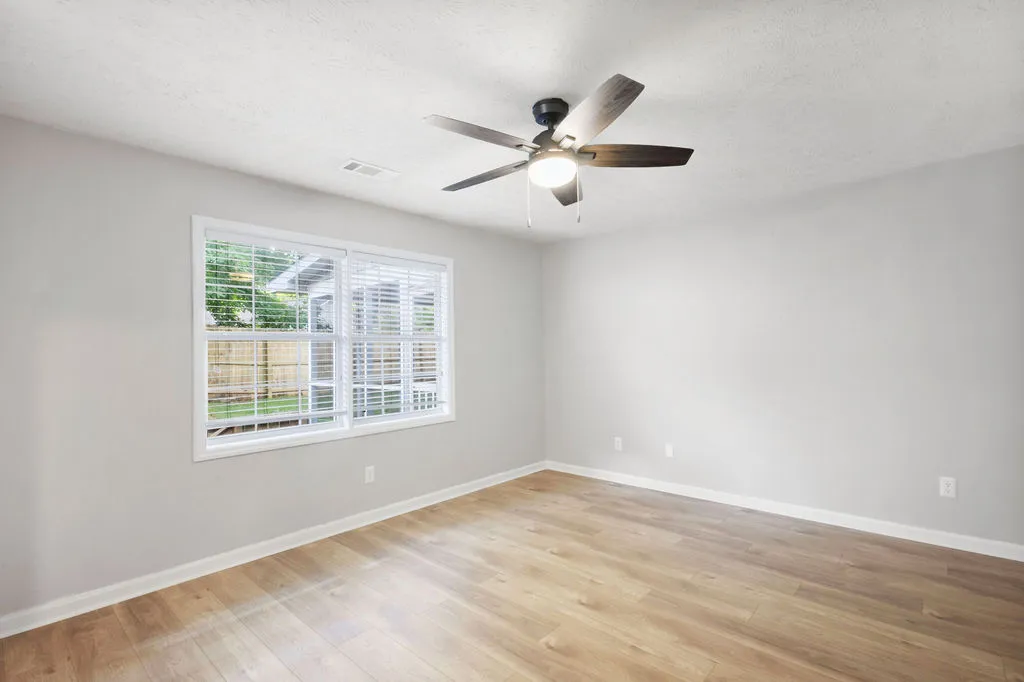 Hardwood floors and generous windows create a light-filled and inviting space, perfect for any use.