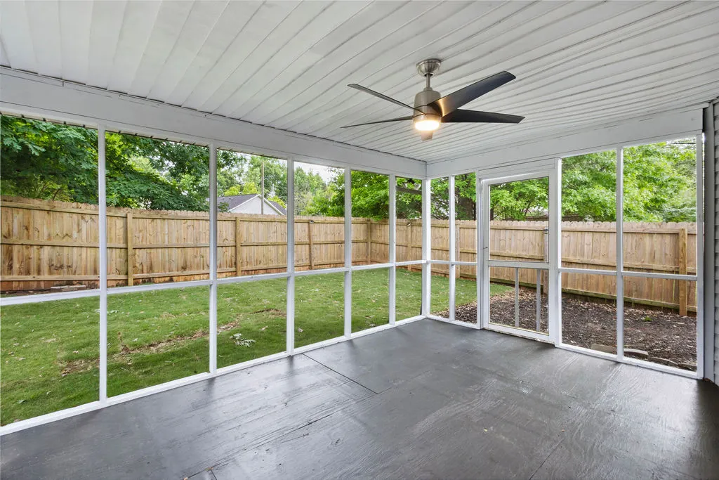 An inviting screened porch provides a peaceful transition to the private fenced yard.