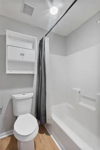 A well-maintained bathroom with a sleek tub and practical storage solutions.