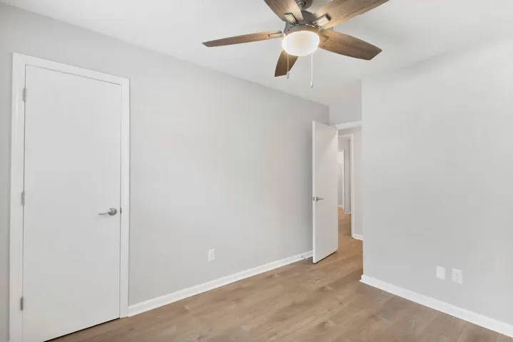 Hardwood-style flooring and a ceiling fan create a comfortable and inviting atmosphere.