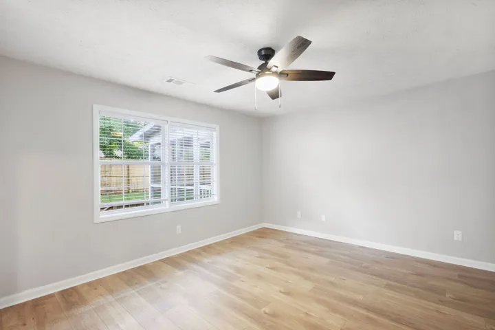Hardwood floors and generous windows create a light-filled and inviting space, perfect for any use.