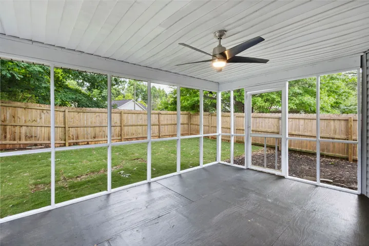 An inviting screened porch provides a peaceful transition to the private fenced yard.