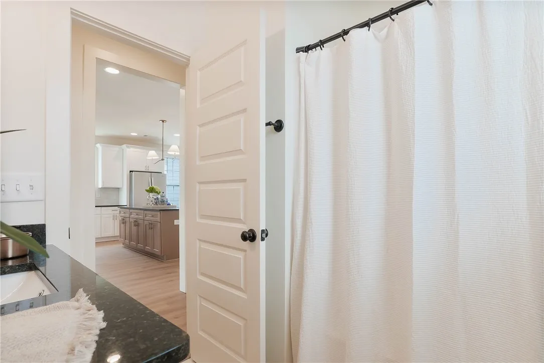 Granite counters and wood flooring create a sleek, functional space.