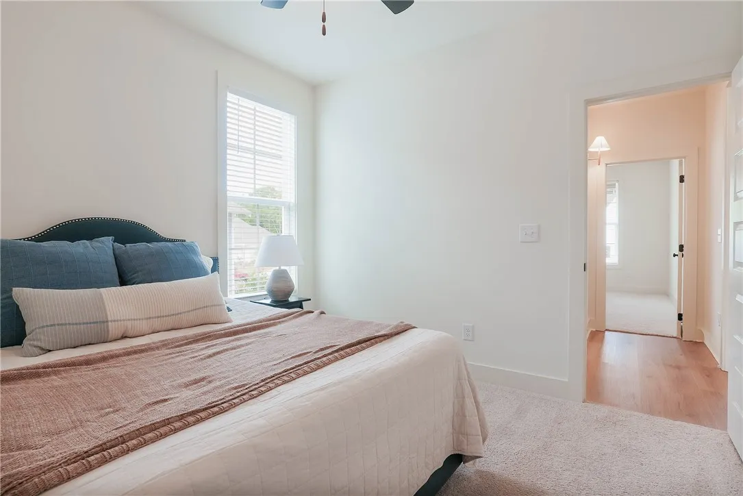 A quiet retreat, this bedroom offers plush carpeting and a naturally lit window.