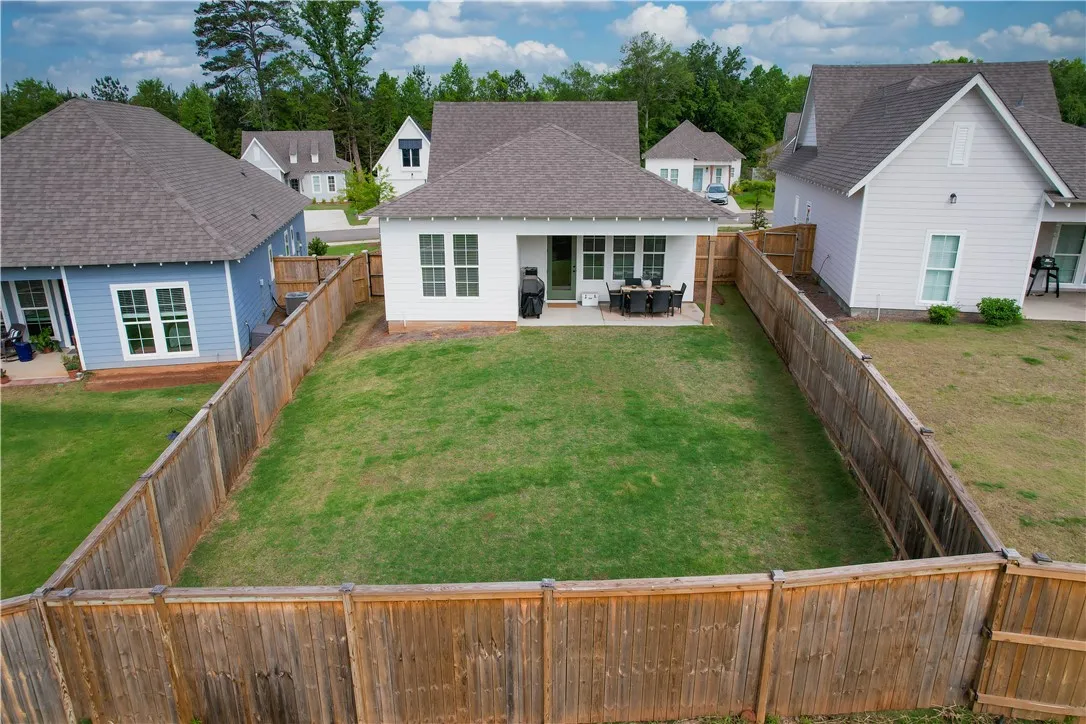 A well-maintained fenced yard offers a serene retreat with a paved patio, ideal for outdoor relaxation.