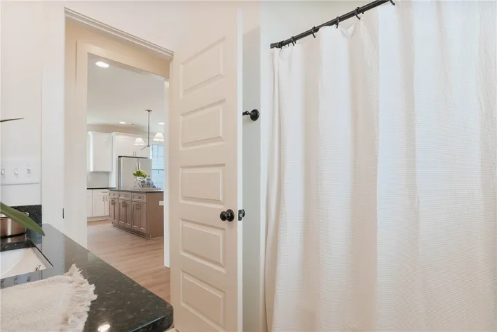 Granite counters and wood flooring create a sleek, functional space.