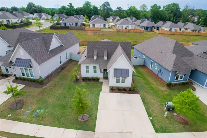 A well-maintained lawn and sturdy asphalt roof adorn this charming new construction.