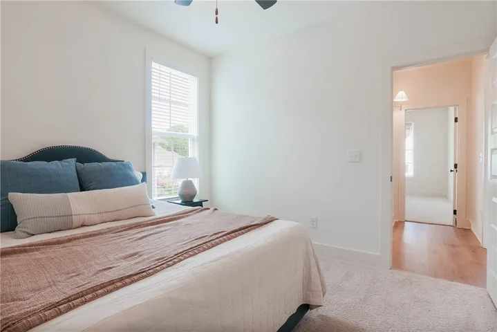 A quiet retreat, this bedroom offers plush carpeting and a naturally lit window.