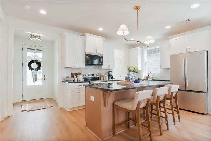 A well-appointed kitchen features a large island and gleaming stainless steel appliances.
