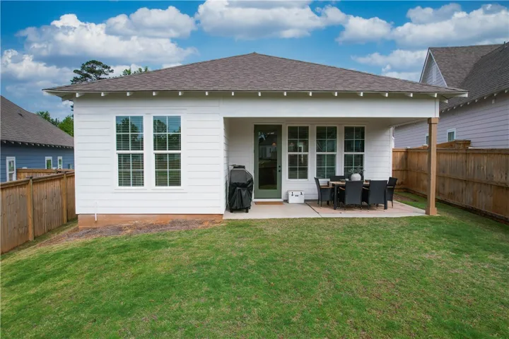 An inviting rear patio provides an ideal setting for al fresco dining and backyard enjoyment.