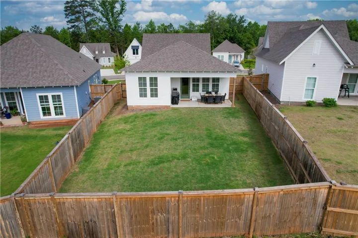 A well-maintained fenced yard offers a serene retreat with a paved patio, ideal for outdoor relaxation.