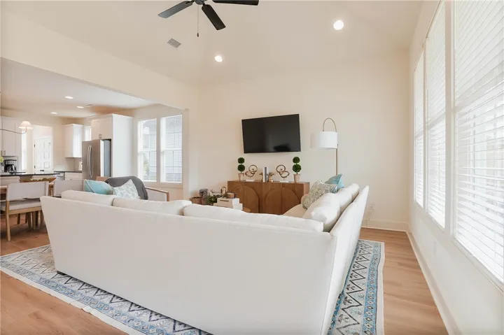 An open-concept living area with ample natural light flows seamlessly into the kitchen and dining space.