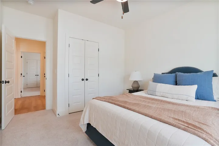 Cozy and serene, this bedroom offers plush carpeting and a spacious closet.