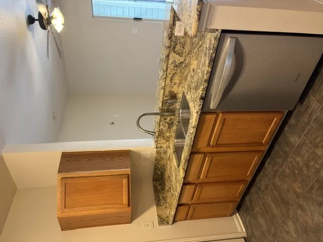 A well-appointed kitchen showcasing durable granite counters and modern stainless steel appliances.