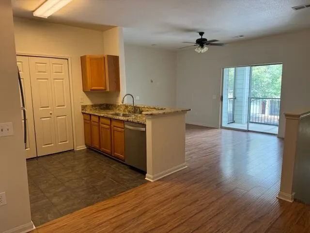 A well-appointed kitchen flows seamlessly into a spacious living area, complete with a private balcony for outdoor enjoyment.