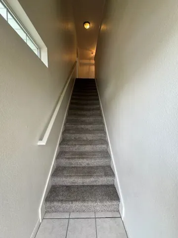 A well-lit stairway offers a clear path to the next level.