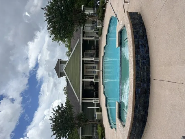An inviting community pool awaits next to the clubhouse, offering refreshing aquatic recreation.