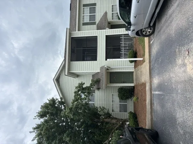 Find convenient living in this second floor unit, featuring a screened porch and ample parking.