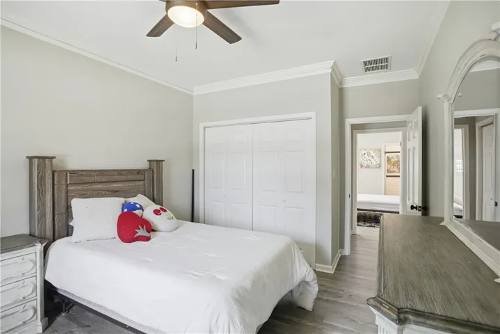 A well-lit bedroom with modern wood flooring and convenient bi-fold closet doors.