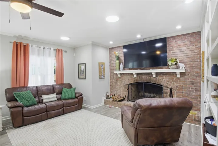 A comforting living space features a prominent brick fireplace, setting a warm and inviting atmosphere.