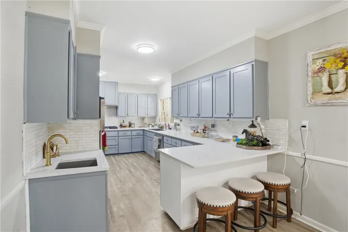 Culinary adventures await in this kitchen, boasting elegant countertops and stylish cabinetry.