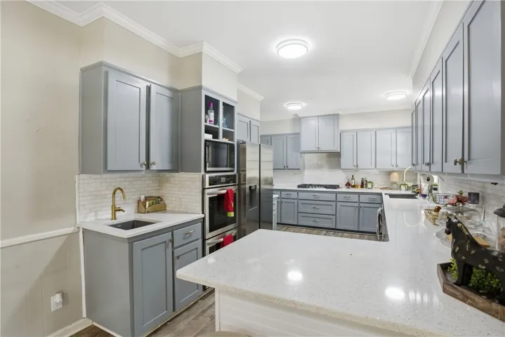 A well-appointed kitchen features ample cabinetry and a practical island, perfect for culinary adventures.