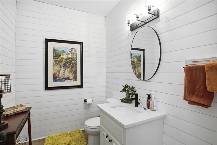 Clean lines and a crisp white vanity define this well-appointed lavatory.
