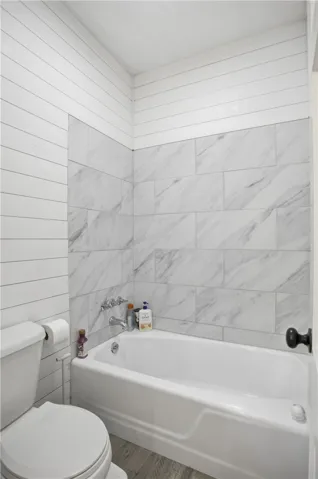 Clean lines and classic tilework adorn this inviting bathroom, offering a serene escape.